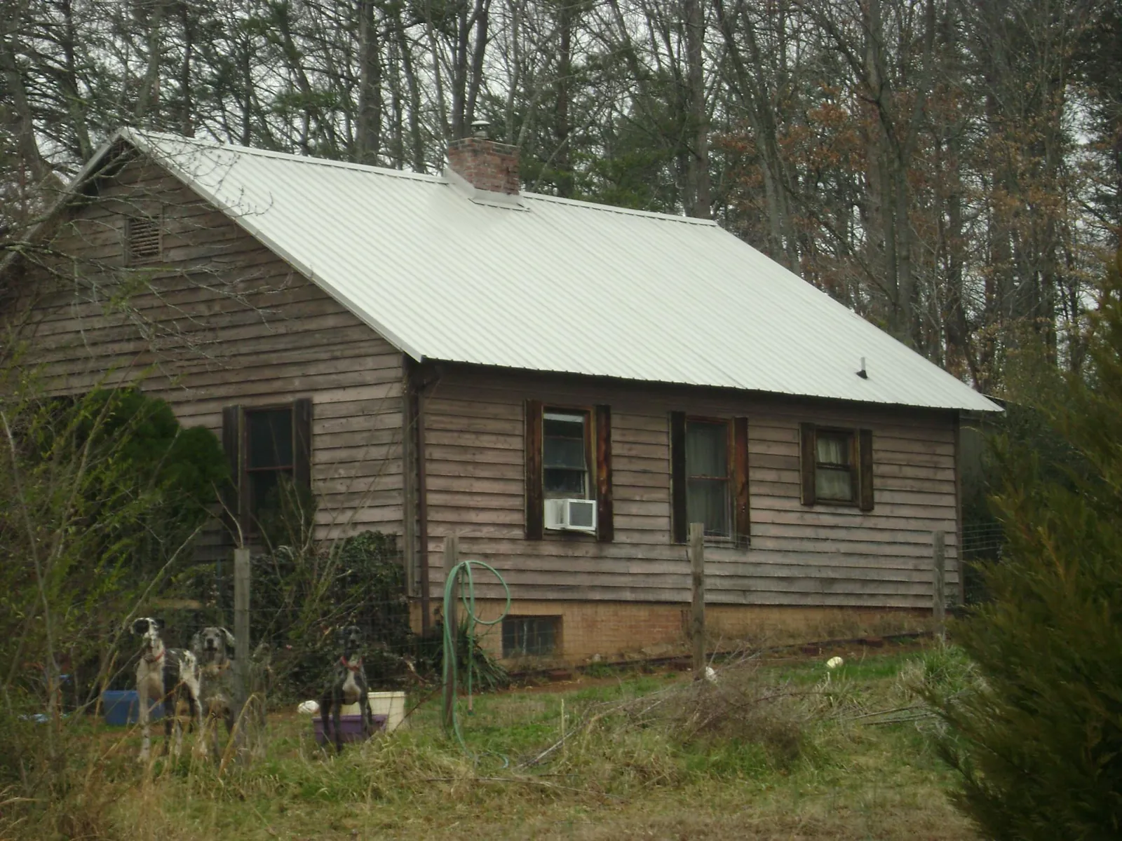 White metal roof on an old wood sided farmhouse, from a Metal Roof Installation job in Spring Valley